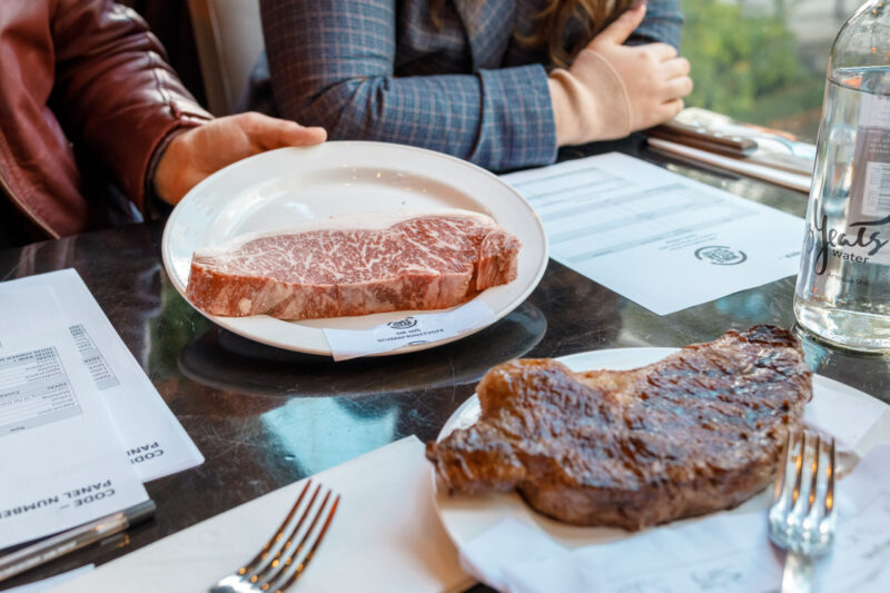 one cooked and one raw steak