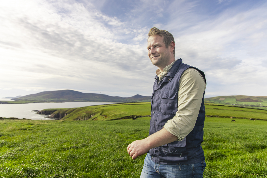 Farmer walking through green field