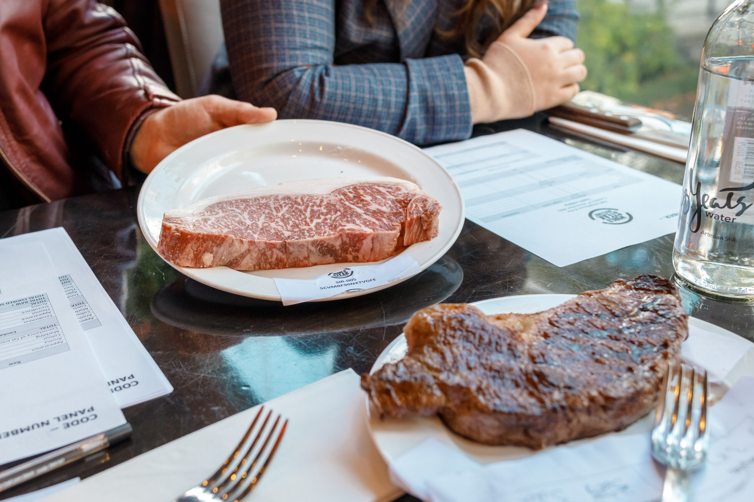 one cooked and one raw steak