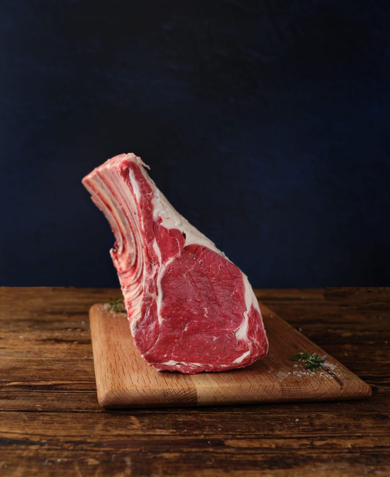 Raw beef rack on chopping board
