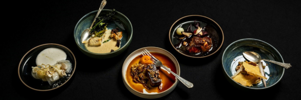 A photo of elaborate deserts with a black background