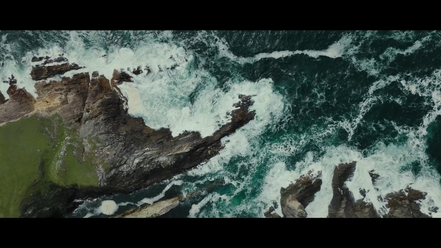 A rock shore with crashing waves