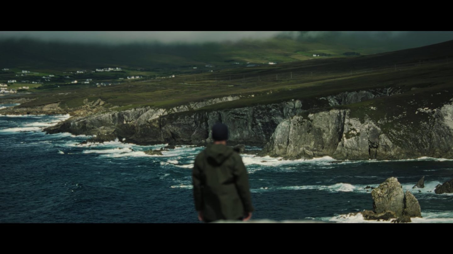 Fisherman standing on cliffside
